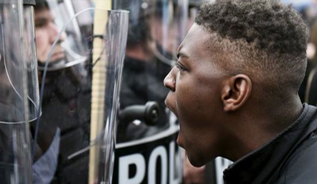 Young Black Man Yells At Police In Riot Gear